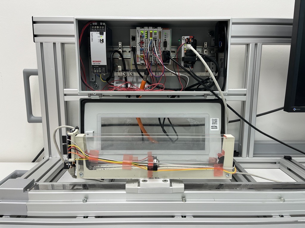 Ball-and-arc experimental setup showing the linear cart, 3D-printed arc with ToF sensors, and Beckhoff servo motor